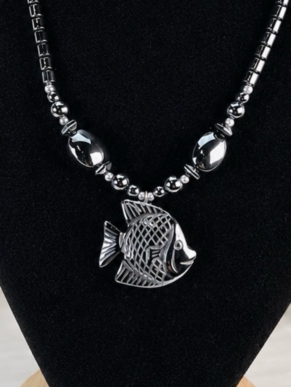 Beautiful weighted, gunmetal tone hematite necklace with fish pendant